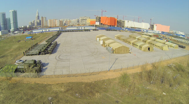 Base with tents and military equipment prepared for Victory Day Parade at spring sunny day, aerial view