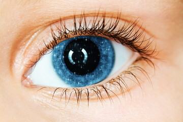 Fototapeta premium Little stars in the iris of the eye, close-up, collage