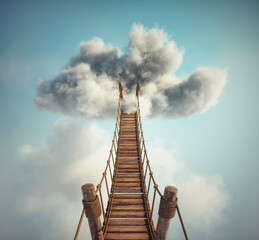 Surreal image of a rope bridge to a cloud. The concept of adventure or getaway.