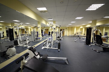 Fototapeta na wymiar Light big gym with many equipment for bodybuilding at the rehabilitation center.