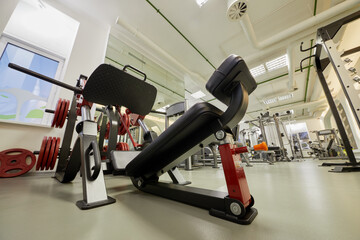 Diagonal leg press training machine in gym room.