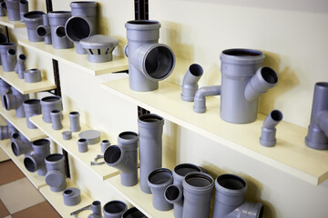 Fittings for plastic piping system on shelves.