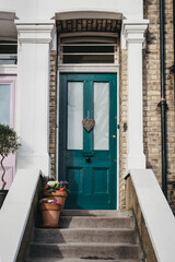 Fototapeta na wymiar Green door on a traditional English house in London, UK.