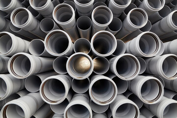 Packaged plastic water pipes at warehouse.