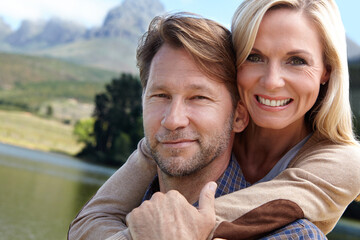 Fototapeta premium Nature, happy and portrait of couple at countryside for summer vacation, holiday and bonding by river. Man, woman and trees with lake for weekend adventure, travel and tourism together in Europe