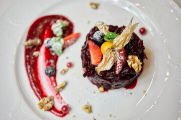 Salad from �aked beetroot with cowberry sauce, berries and wallnut.