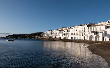 Fototapeta premium Morning sun illumitates white buildings on the bay of a small Spanish town