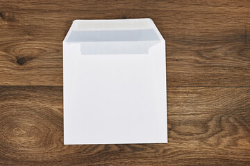 White envelope mock-up, blank template on wood table