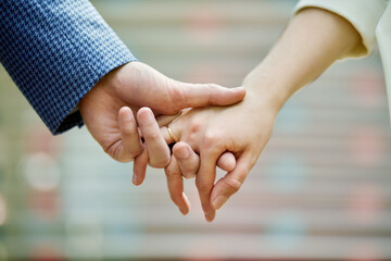 Couple hands held together, closeup.