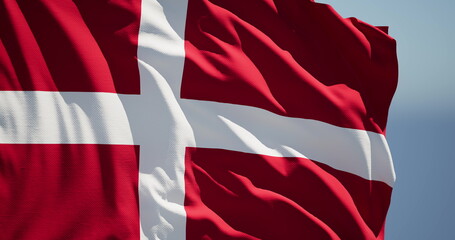 Close-up of the national flag of kingdom Denmark flutters in the wind on a sunny day