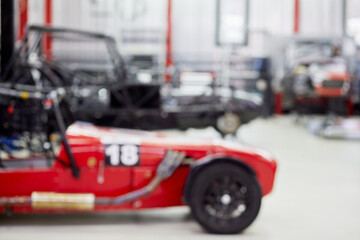 Fototapeta premium (PR) Sports racing cars in garage box of DB 527 company producer of russian sports cars, out of focus.