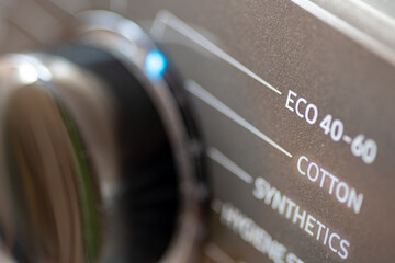 A energy saving, environmental concept with a washing machine setting on eco wash.