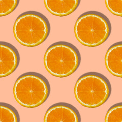 Uniform pattern of orange slices with shadow on peach trendy background. Flat layout
