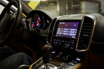 Interior of modern car cabin, focus on on-board computer screen.