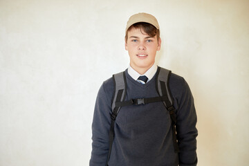 Portrait of smiling schoolboy in cap with rucksack. © Pavel Losevsky