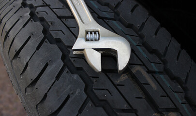12 Inch Adjustable Spanner On A New Tire Close Up Angle View 
