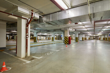 Interior of spacious empty underground parking.