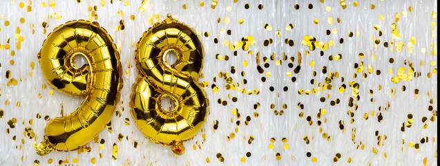 Gold foil balloon number, digit ninety-eight. Birthday greeting card with inscription 98....