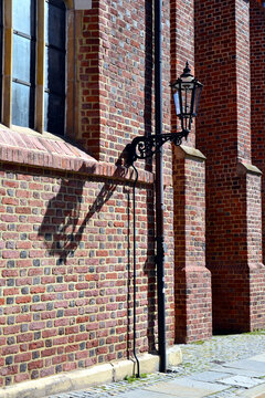 Gas street lamp, lantern. The Cathedral Island (polish: Ostrow Tumski) in Wroclaw, Poland. One of the few remaining places in Europe where a lamplighter lights the gas street lamps every evening