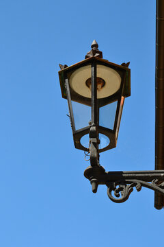 Gas street lamp, lantern. The Cathedral Island (polish: Ostrow Tumski) in Wroclaw, Poland. One of the few remaining places in Europe where a lamplighter lights the gas street lamps every evening