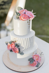 beautiful wedding cake near the wedding arch in the evening