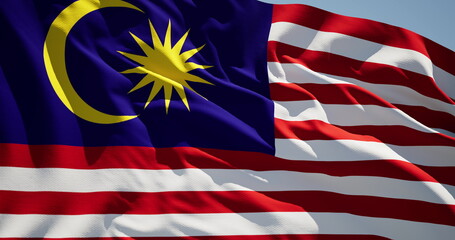 Close-up of the national flag of Malaysia flutters in the wind on a sunny day