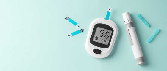 Blood glucose meter, diabetes checking sugar level on light green background