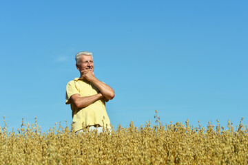 Portrait of senior man resting in field