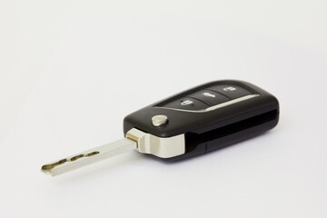 Car key with remote control on white background, shallow dof.