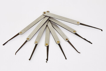Set of lock picks on white background.