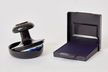 Stamp and ink pad on white background.
