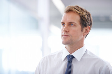 Fototapeta premium Businessman, serious and thinking in the morning in office with corporate ideas, daydreaming and wondering. Entrepreneur, professional and thoughtful man at workplace with mockup space and confidence