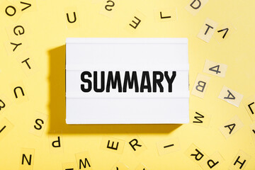 Summary word written in letters on lightbox with yellow background