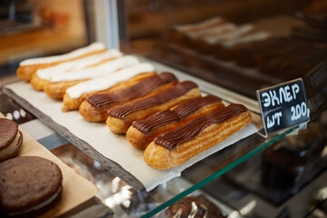 Eclairs in shop window in confectioner shop, shallow dof.