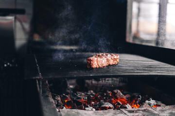 Beef steaks on the grill with flames
