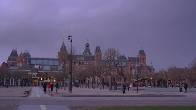 Netherlands, March 28 2023: Amsterdam at summer night. Famous national Rijks museum general view at dusk 4k
