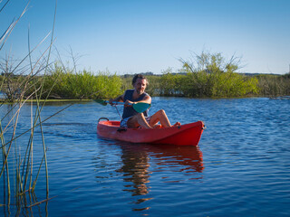 Fototapeta na wymiar Front view of man in a kayak on a lagoon 