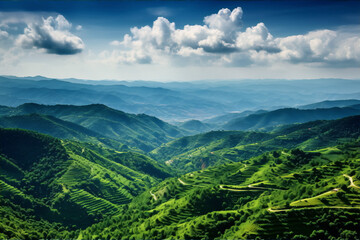 Obraz premium Green mountain ranges under blue sky and white clouds