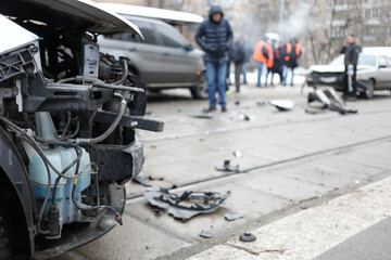 Group car accident with many damages in city, people out of focus at winter