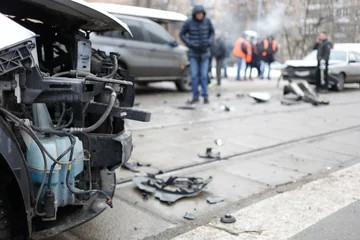 Foto op Plexiglas Group car accident with many damages in city, people out of focus at winter © Pavel Losevsky