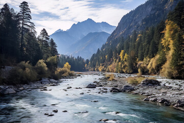 The image is of a mountain river in a valley with autumn trees on the banks under a blue sky with white clouds.