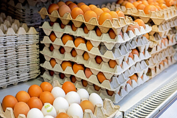 close-up of farm brown chicken eggs in cardboard containers on a store counter