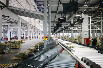 Fototapeta premium Working people in warehouse and sorting center of Ozon internet shop, it takes sixth place in list of most expensive russian internet companies