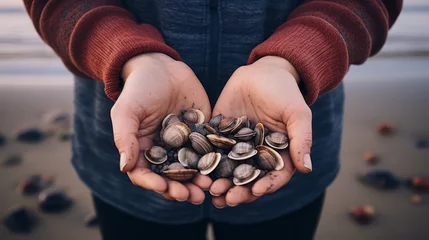 Gartenposter Cupped hands present a treasure trove of various seashells. Each shell a memory, each memory a wonder. © Stavros