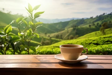 Rolgordijnen a cup of tea on a wooden table with a tea plantation backdrop © Muh