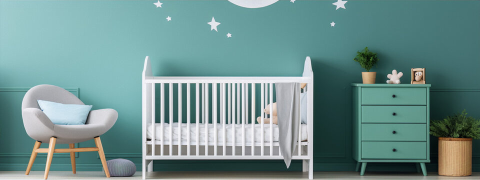 A modern nursery with a white crib, a gray chair, and a green dresser. The walls are painted green and decorated with white stars and a moon.