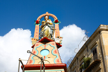 Wooden sculpture of Madonna Vasa Vasa on the bright sicilian cart in Palermo, Sicily, Italy
