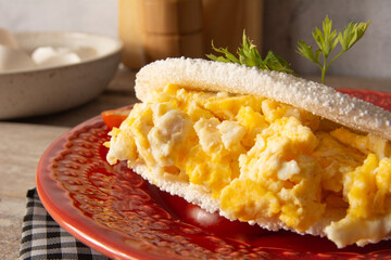 Tapioca Pancake with eggs Brazilian manioc food in top front view red plate