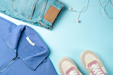 Outfit for teenagers on a blue background. Casual street style, top view point, flat lay.