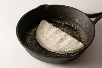 Tapioca Pancake Brazilian manioc food in top front view inside steel skillet pan clean background